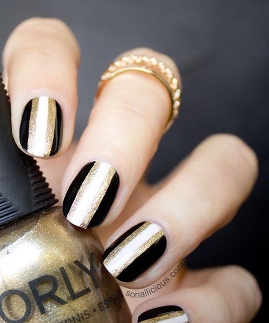 Black and Gold Almond Shaped Nails.jpg