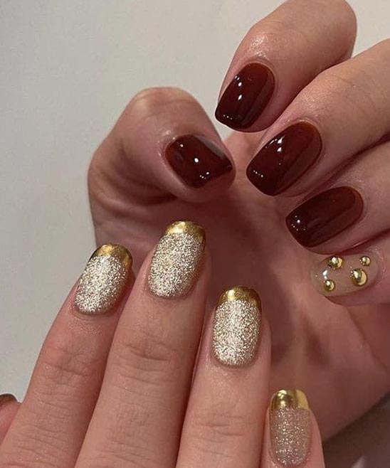 Burgundy and Gold Tipped Nails